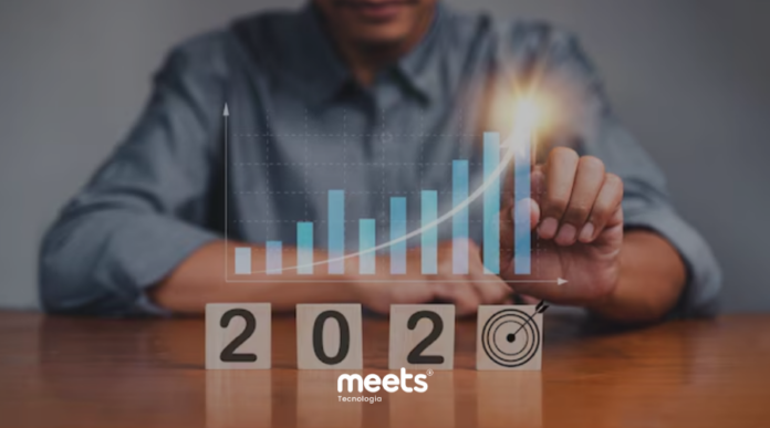 Gráfico de barras ascendente sobre blocos de madeira com o ano 2026 e um alvo, simbolizando o alcance de metas e crescimento empresarial.